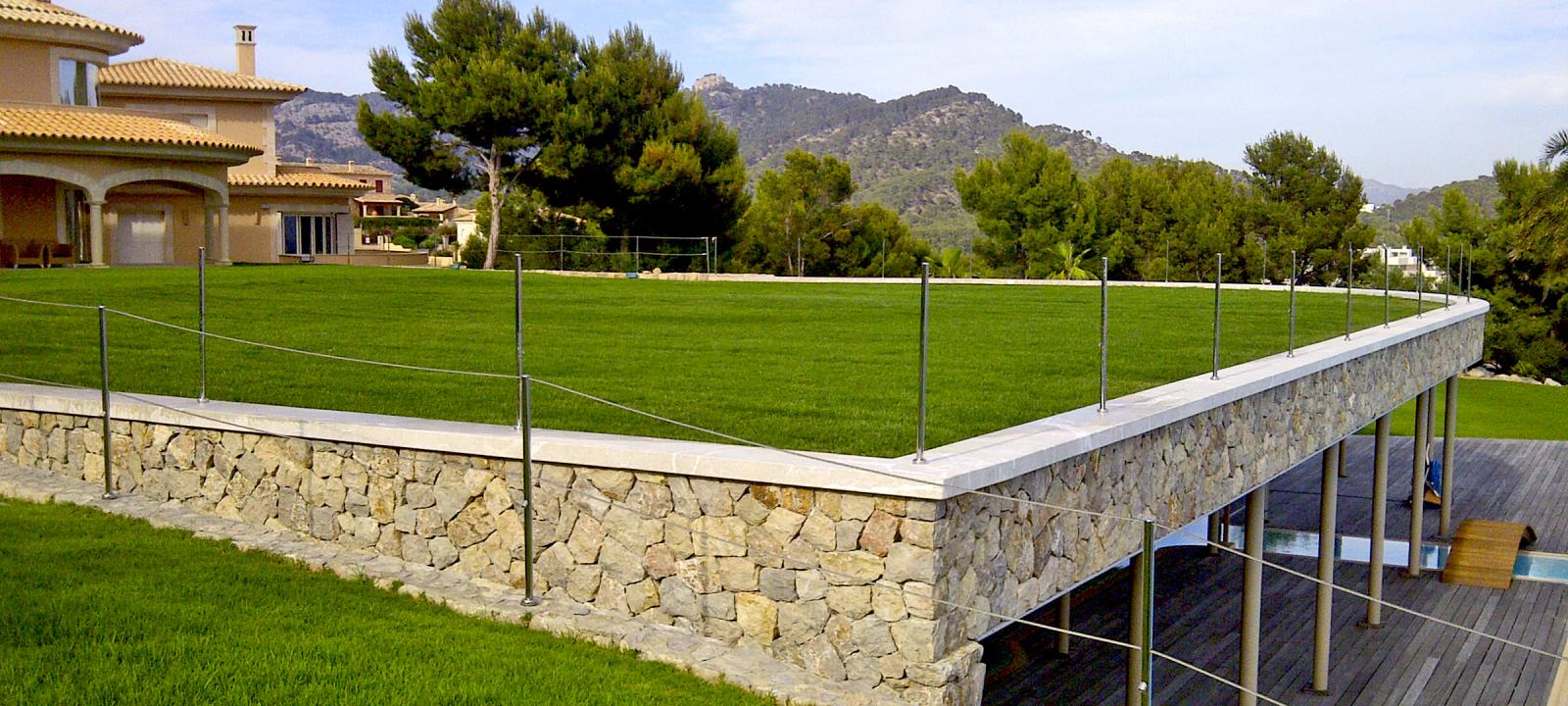 Natural stone building with a green roof with lawn